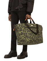 Nylon travel bag with leopard print against a green background and branded plate - | Dolce & Gabbana