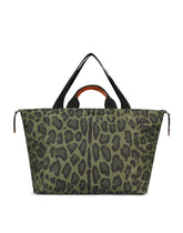 Nylon travel bag with leopard print against a green background and branded plate - | Dolce & Gabbana
