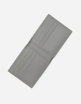 Calfskin bifold wallet with raised logo - | Dolce & Gabbana