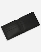 Calfskin bifold wallet with raised logo - | Dolce & Gabbana