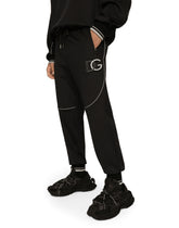 Jogging pants with embossed DG logo - | Dolce & Gabbana