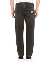Loose light gray jeans with repaired rips - | Dolce & Gabbana