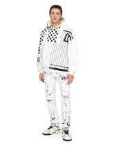 Slim-fit stretch jeans with rips and splash design - | Dolce & Gabbana