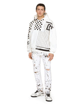 Slim-fit stretch jeans with rips and splash design - | Dolce & Gabbana