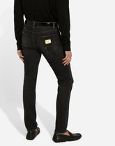 Slim-fit gray stretch denim jeans with abrasions - | Dolce & Gabbana