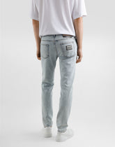 Slim-fit stretch cotton jeans with tag - | Dolce & Gabbana