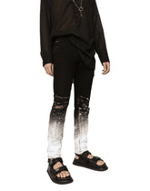 Slim-fit stretch jeans with brushstrokes and DG logo - | Dolce & Gabbana