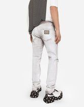 Coated skinny stretch jeans with rips - | Dolce & Gabbana