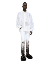 Skinny stretch jeans with rips and brushstrokes - | Dolce & Gabbana