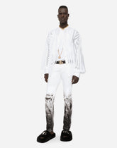 Skinny stretch jeans with rips and brushstrokes - | Dolce & Gabbana
