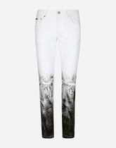 Skinny stretch jeans with rips and brushstrokes - | Dolce & Gabbana