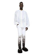 Skinny stretch jeans with rips and brushstrokes - | Dolce & Gabbana