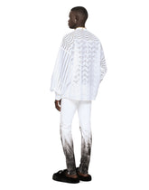 Skinny stretch jeans with rips and brushstrokes - | Dolce & Gabbana