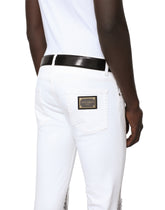 Skinny stretch jeans with rips and brushstrokes - | Dolce & Gabbana