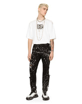 Skinny stretch jeans with rips and splash design - | Dolce & Gabbana