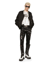 Skinny stretch jeans with rips and splash design - | Dolce & Gabbana