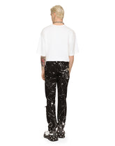 Skinny stretch jeans with rips and splash design - | Dolce & Gabbana