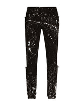 Skinny stretch jeans with rips and splash design - | Dolce & Gabbana