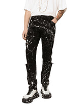 Skinny stretch jeans with rips and splash design - | Dolce & Gabbana