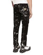 Skinny stretch jeans with rips and splash design - | Dolce & Gabbana