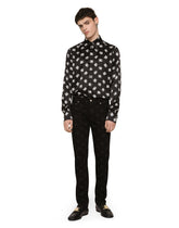 Black skinny jeans with all-over DG logo print - | Dolce & Gabbana