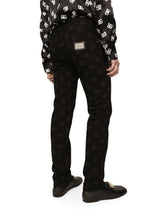 Black skinny jeans with all-over DG logo print - | Dolce & Gabbana
