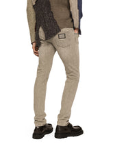 Washed stretch denim jeans with abrasions - | Dolce & Gabbana