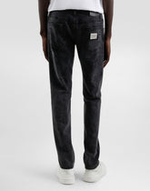 Skinny jeans in stretch cotton with plaque - | Dolce & Gabbana