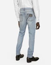 Regular fit washed stretch denim jeans with abrasions - | Dolce & Gabbana