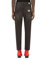 Loose black wash jeans with rips and DG patch - | Dolce & Gabbana
