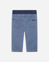 Blue stretch denim pants with a logo plaque - | Dolce & Gabbana