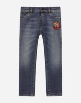 Slim-fit blue wash jeans with heraldic patch - | Dolce & Gabbana