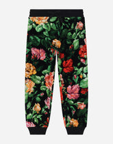 Chenille jogging pants with rose print over a black background - | Dolce & Gabbana