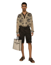 Washed denim Bermuda shorts with rips -  | Dolce & Gabbana