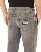 Light blue skinny stretch jeans with frayed turn-ups -  | Dolce & Gabbana