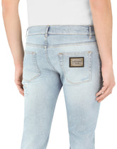 Light blue skinny stretch jeans with rips -  | Dolce & Gabbana