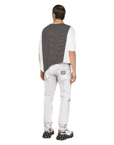 Coated skinny stretch jeans with rips -  | Dolce & Gabbana