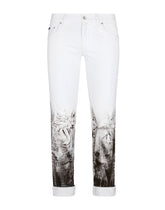 Skinny stretch jeans with rips and brushstrokes -  | Dolce & Gabbana