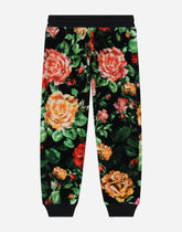 Chenille jogging pants with rose print over a black background -  | Dolce & Gabbana